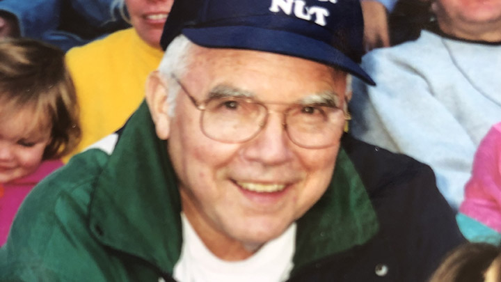 A middle-aged man with a beaming smile donning a Detroit Tigers ballcap.